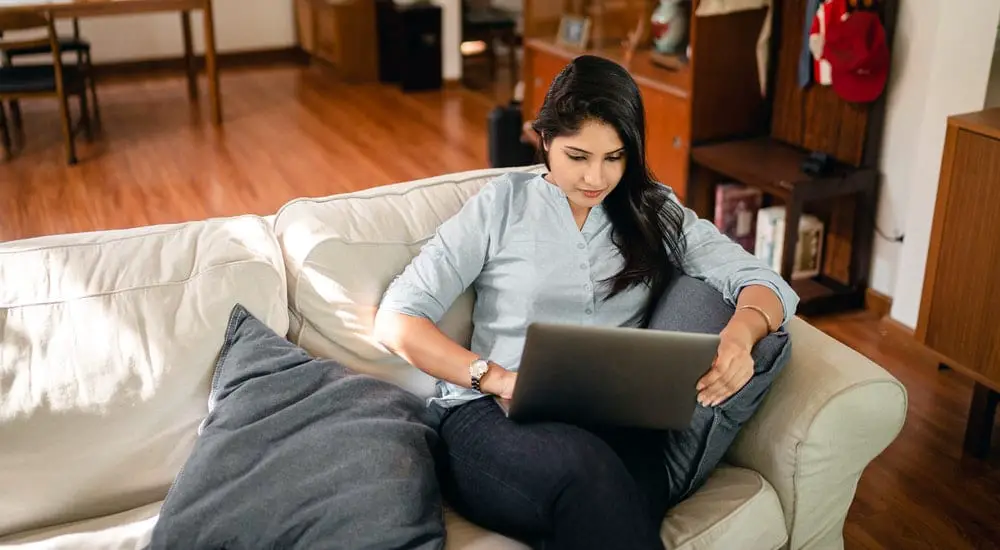Focused Young Indian Woman Typing on Laptop at Home