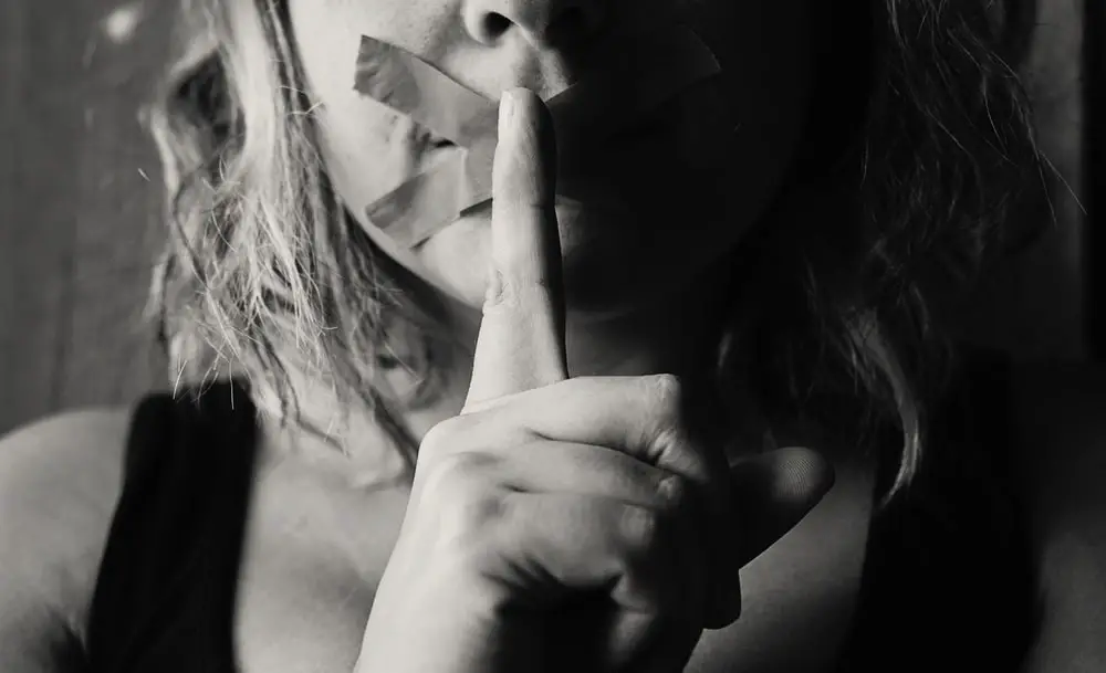 Woman Placing Her Finger Between Her Lips